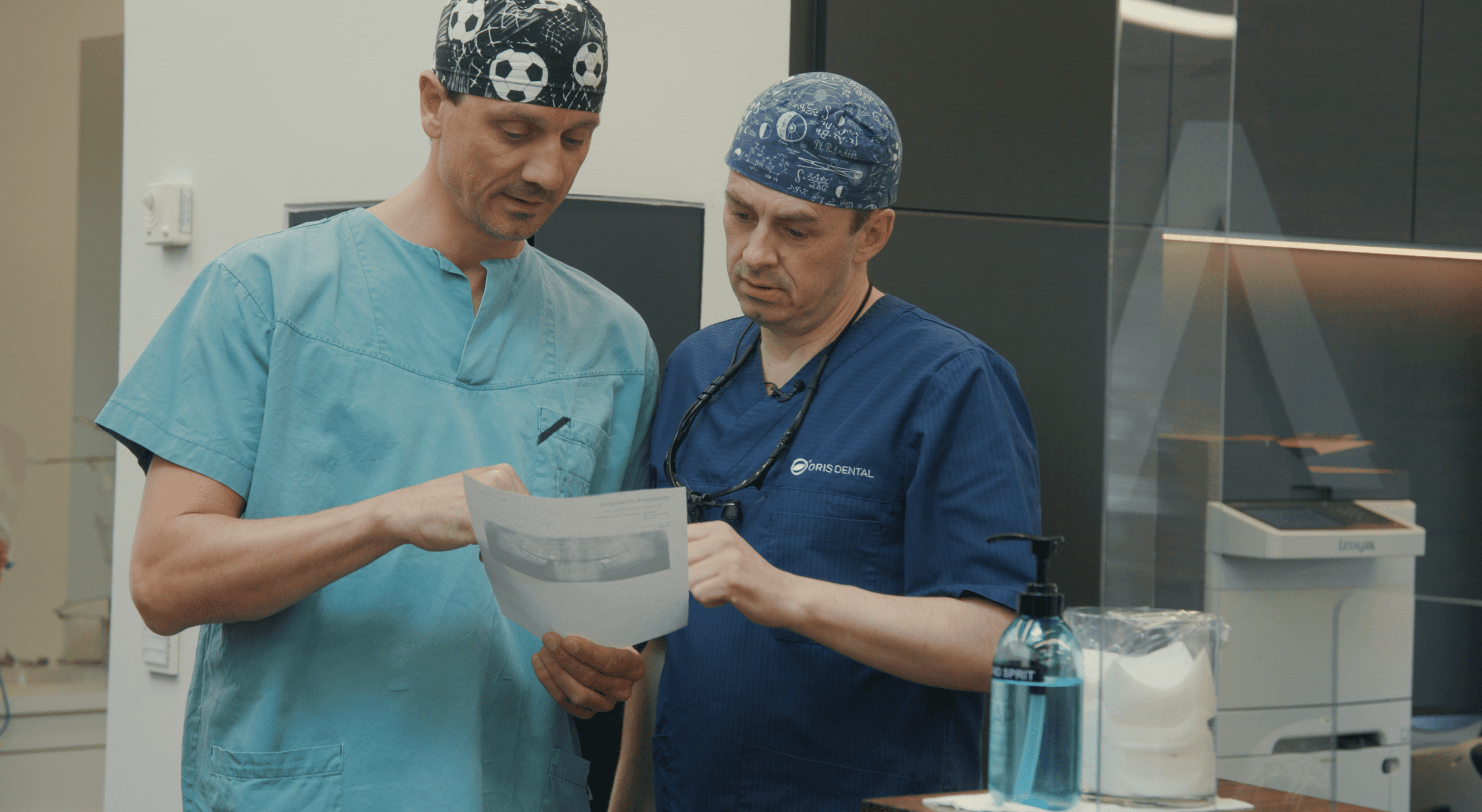 Tannlegene Eirik Salvesen og Stian Solli Kanestrøm leser fagartikkel på tannklinikken om smittevern.